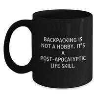 Load image into Gallery viewer, Funny Backpacking Mugs Gifts from Friends and Family for Valentine's - 'Backpacking Is Not A Hobby. It's A Post-apocalyptic Life Skill.' Black Coffee Mug - Main
