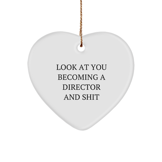 Funny Director Heart Ornament, Gift from Friends to Director, Christmas Ornament with Humorous Quote 'Look At You Becoming A Director And Shit' - Heart Shaped Sturdy MDF Ornament with Gold-Tone String - Image 1