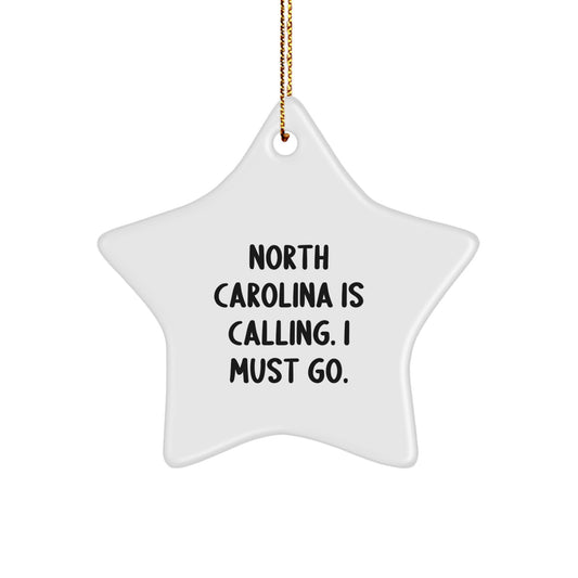 Funny North Carolina Gifts from Friends to Family, Star Ornament with 'North Carolina Is Calling. I Must Go.' Quote, White Star Shaped Christmas Unique Decorations - Image 1